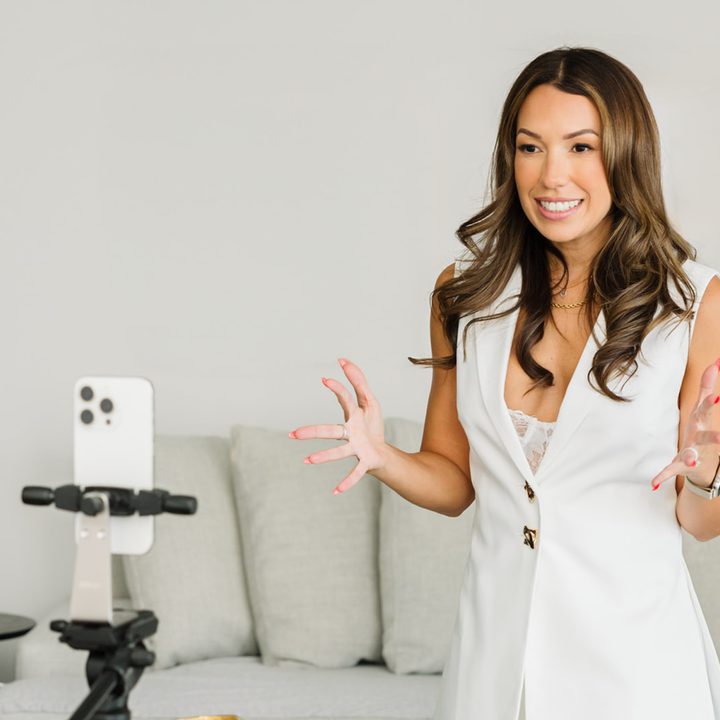 Tracy filming content on her phone