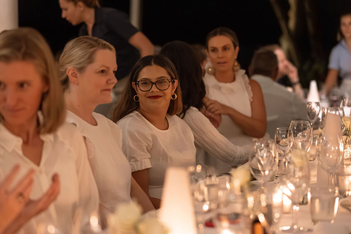 Women in conversation at a candlelit mastermind dinner