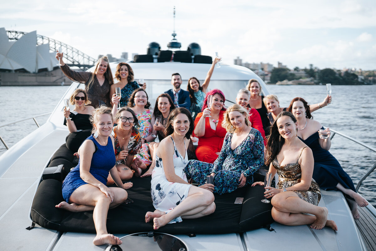 The group together aboard a boat on the harbour