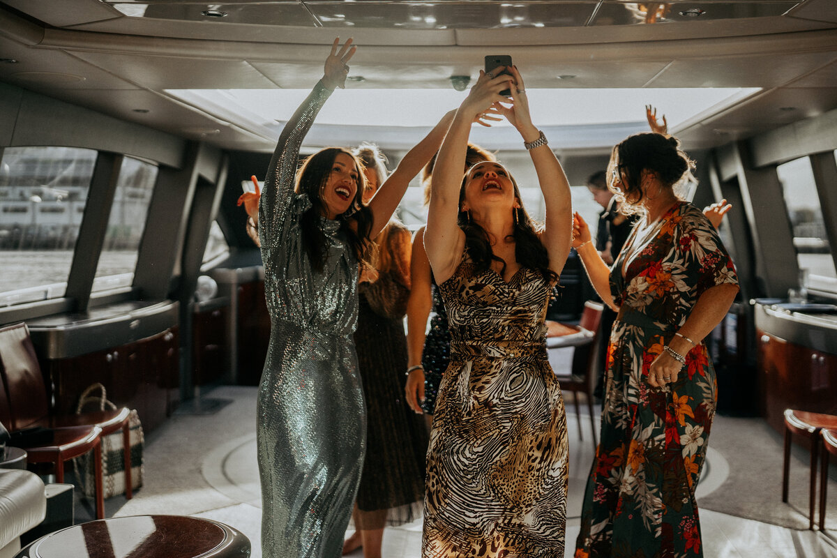 Women dancing together, arms raised