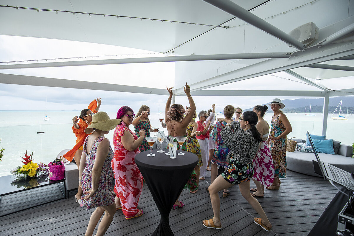Women dancing at a waterfront celebration