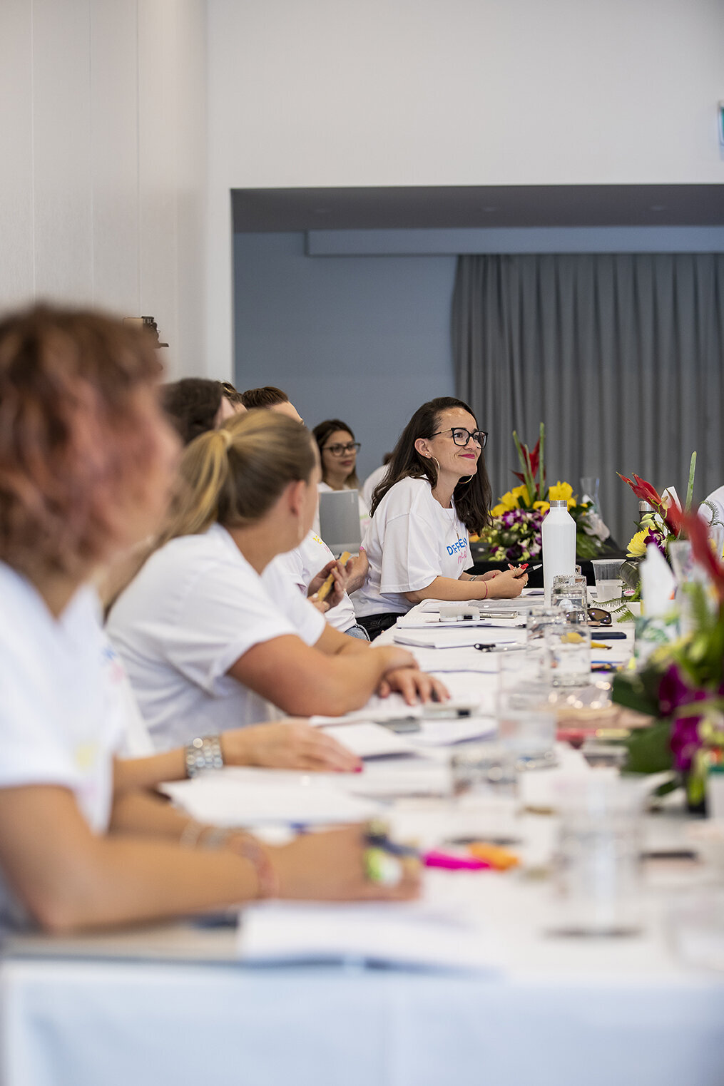 Women working together at a long table during a retreat
